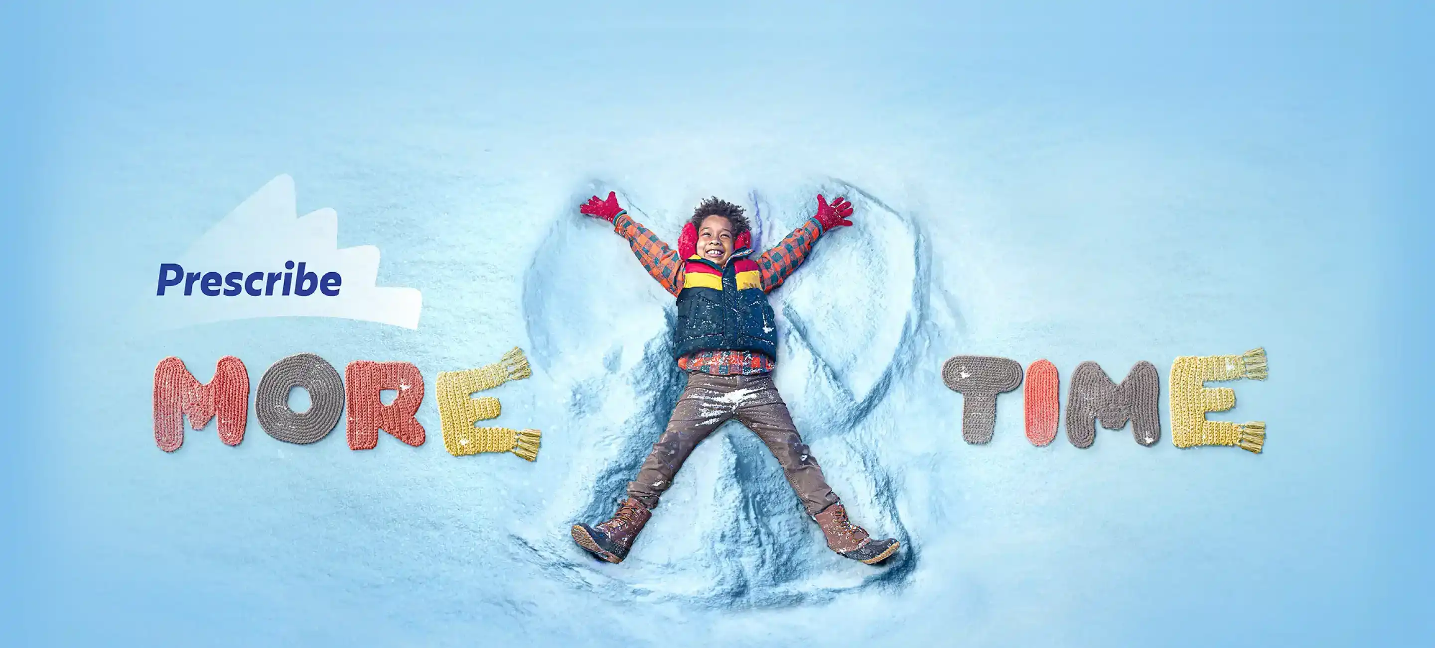 A smiling child making a snow angel. The words &quot;Prescribe More Time&quot; are shown to the side.