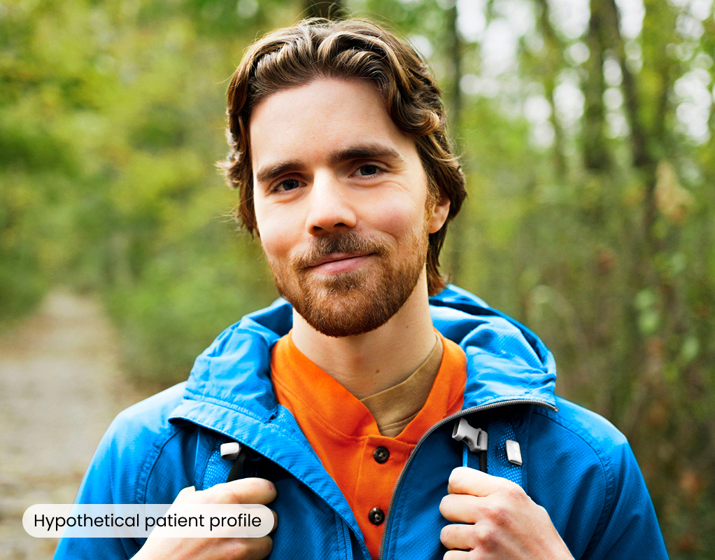 A man hiking outdoors and smiling