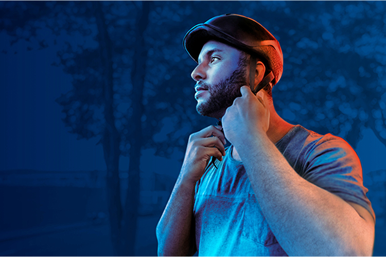 A man putting on his bicycle helmet