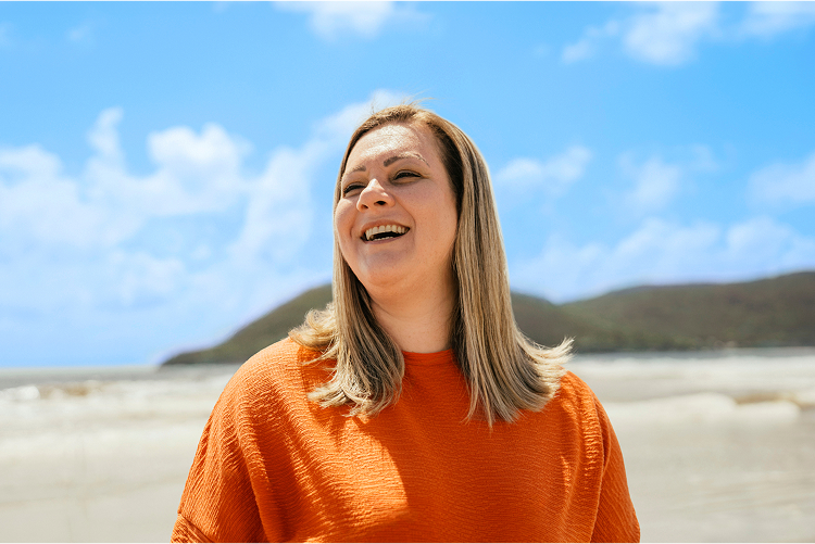 A woman laughing and looking to the side