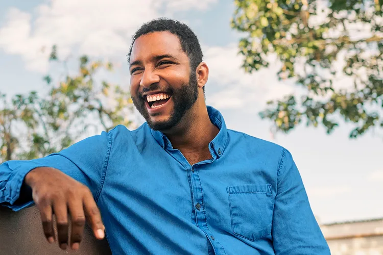 A man smiling outdoors