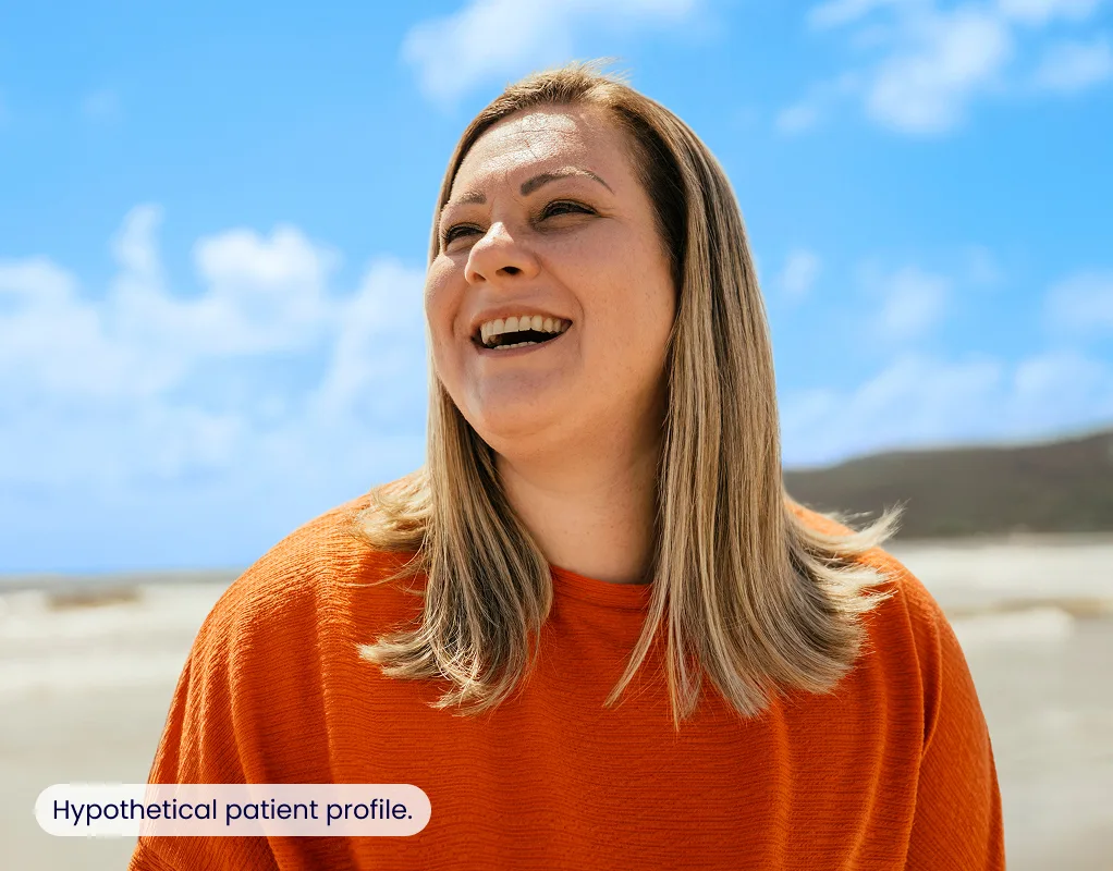 A woman laughing and looking to the side