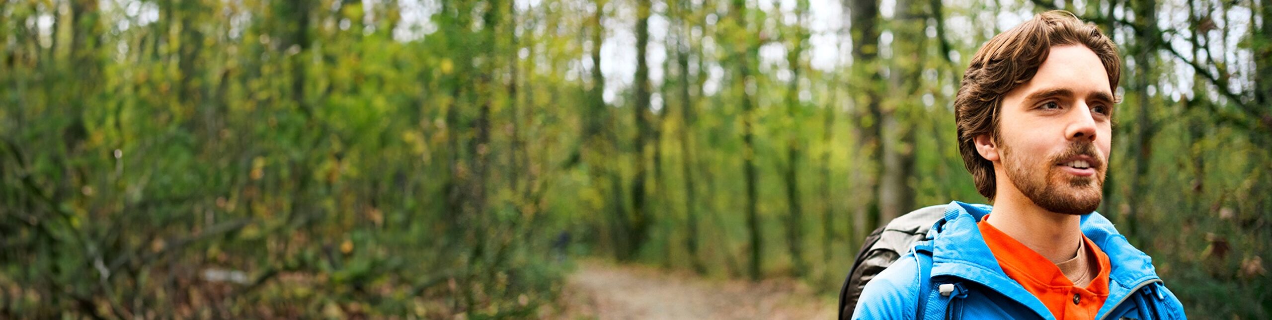 A man hiking outdoors and looking to the distance