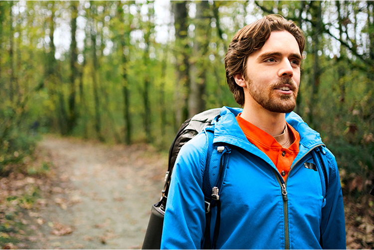 A man hiking outdoors and looking to the distance