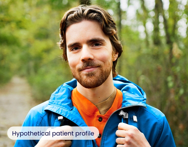 A man hiking outdoors and smiling