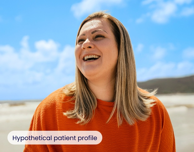 A woman laughing and looking to the side